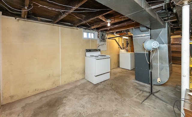 basement featuring separate washer and dryer and heating unit