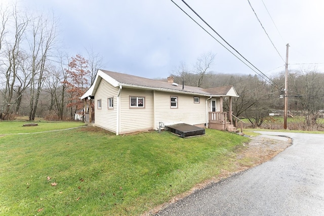 view of property exterior with a yard