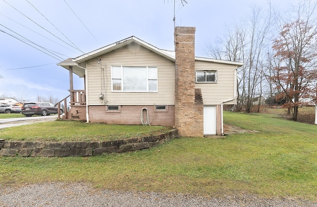 view of side of home with a lawn and a garage