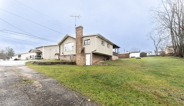 view of side of home featuring a lawn