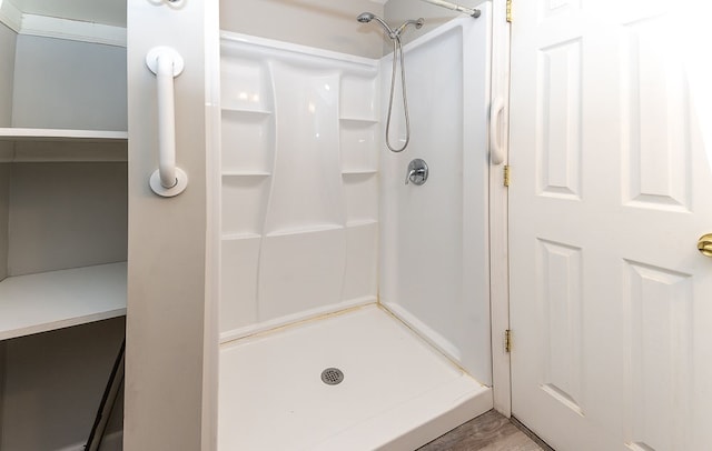 bathroom featuring hardwood / wood-style floors and a shower