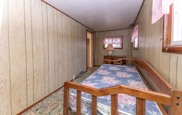 hall with a wealth of natural light and wood walls