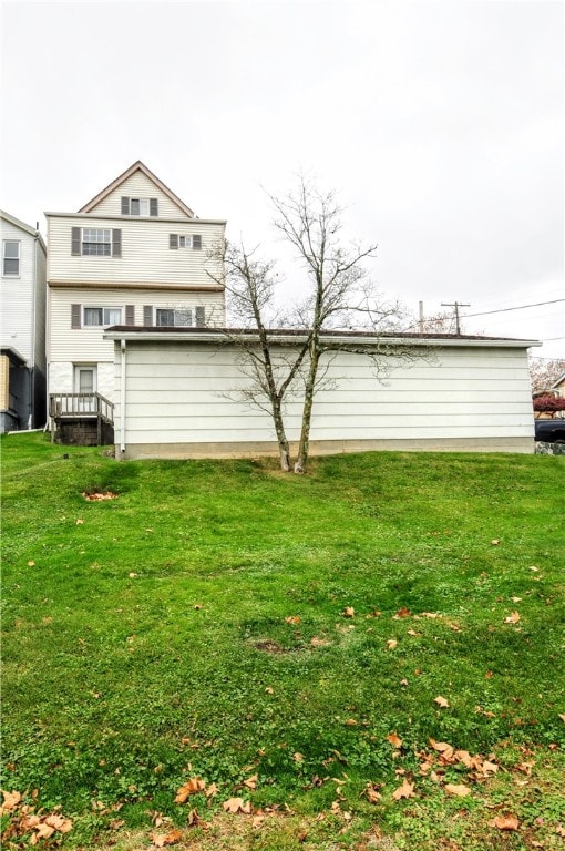 rear view of house featuring a lawn