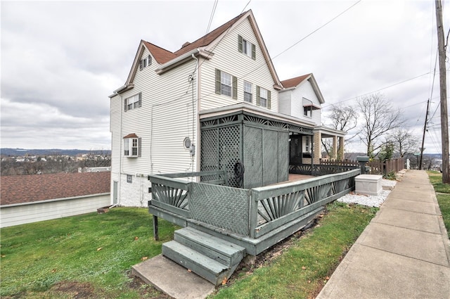 view of side of home with a yard