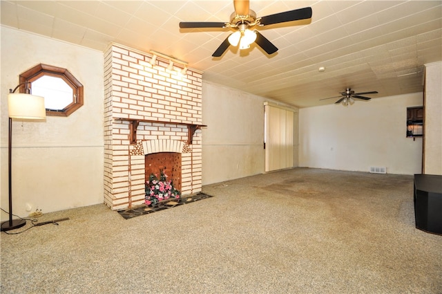 unfurnished living room with carpet floors, ornamental molding, and a brick fireplace