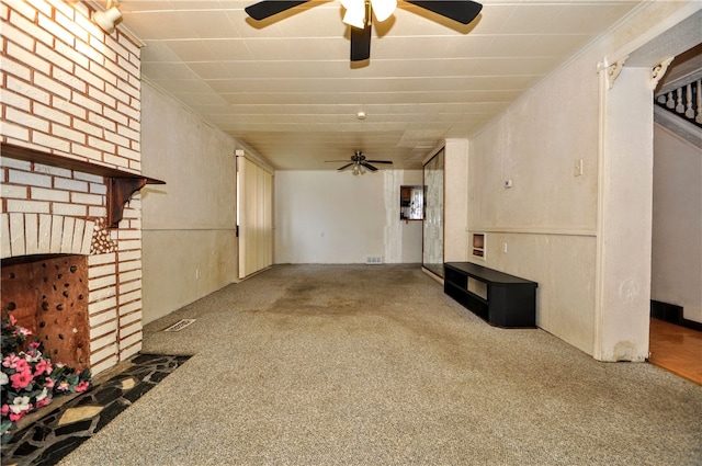 unfurnished living room with carpet flooring and a fireplace