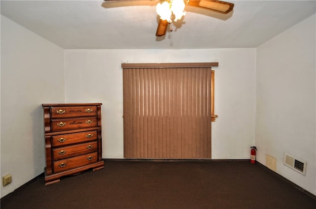 spare room featuring ceiling fan and carpet floors