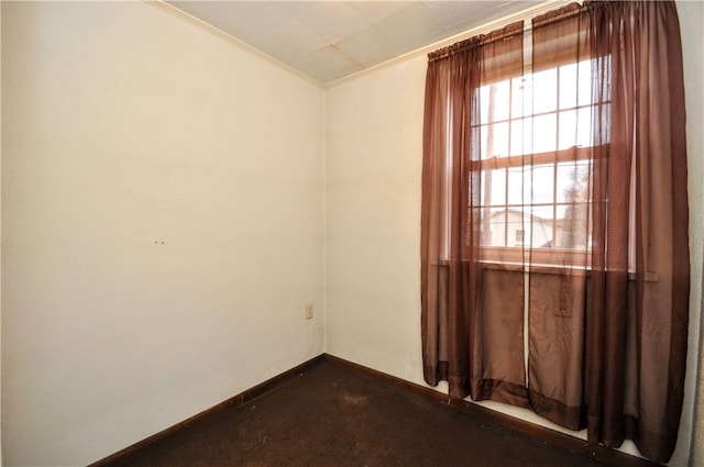 unfurnished room featuring crown molding