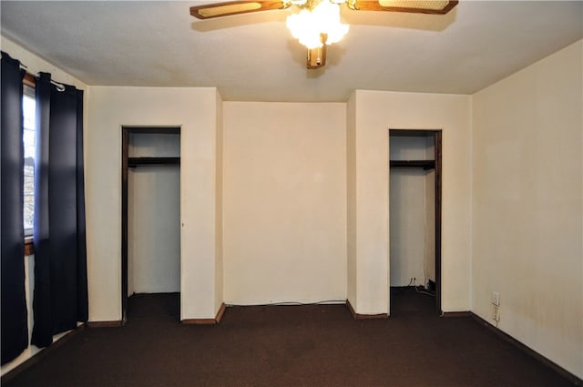 unfurnished bedroom with dark colored carpet and ceiling fan