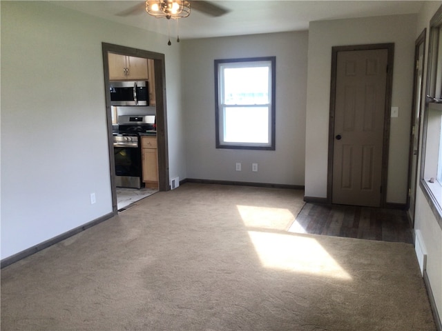 spare room with ceiling fan and dark wood-type flooring