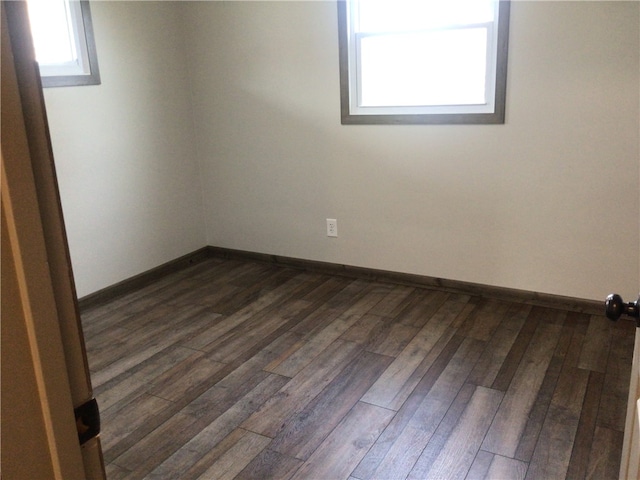 spare room featuring dark hardwood / wood-style flooring