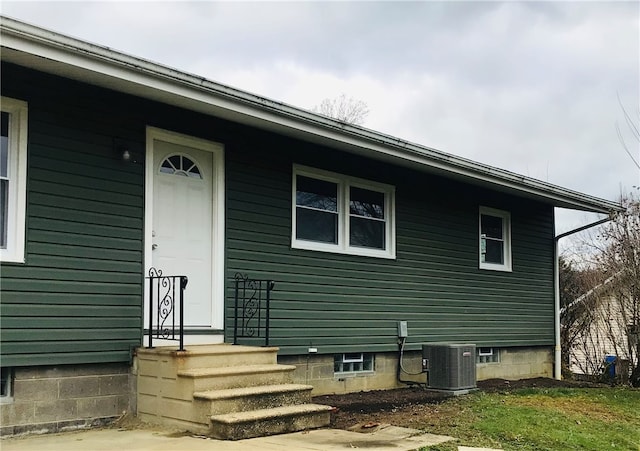 property entrance with central AC unit