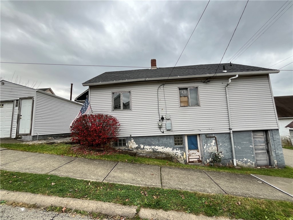 rear view of house with a garage