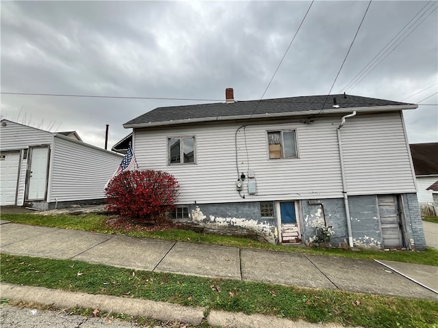 rear view of house with a garage