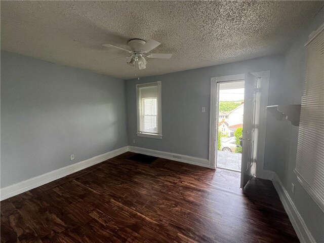 431 Euclid Ave, Glassport, PA 15045 - empty room with dark wood-style flooring, a textured ceiling, healthy amount of natural light, baseboards, and a ceiling fan