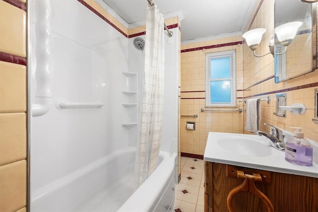 bathroom with shower / bathtub combination with curtain, vanity, ornamental molding, and tile walls