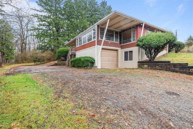 view of side of property with a sunroom and a garage