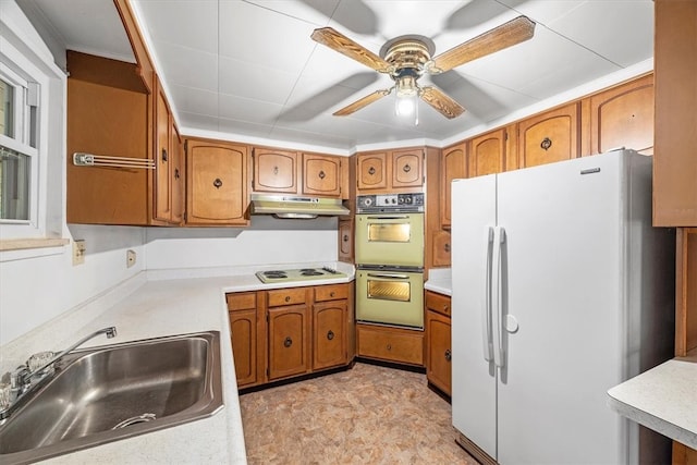 kitchen with ceiling fan, white appliances, and sink