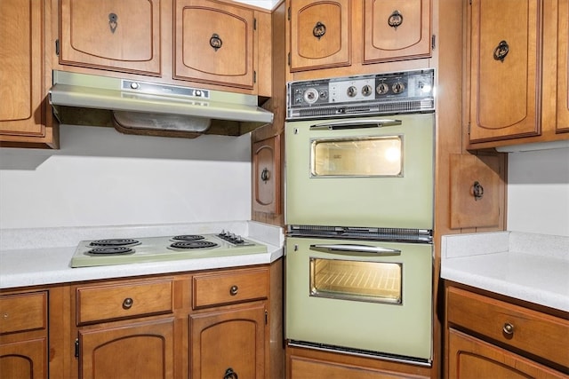 kitchen with double oven and white stovetop