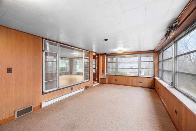 unfurnished sunroom with a baseboard heating unit