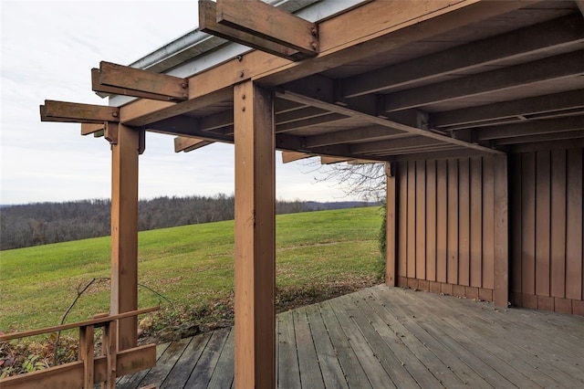 wooden deck with a rural view and a lawn