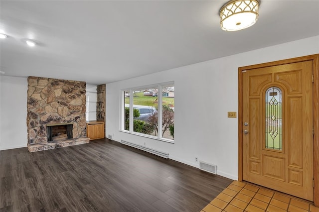 foyer featuring a fireplace, hardwood / wood-style floors, and baseboard heating