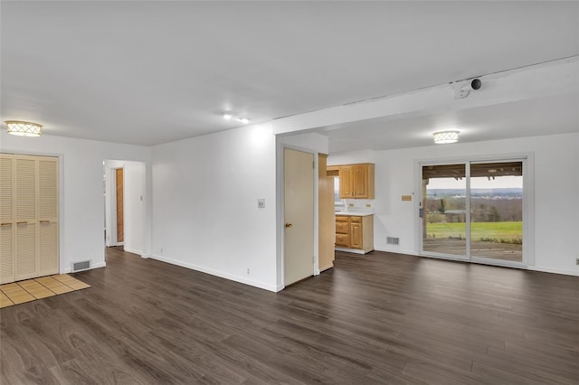 unfurnished living room with dark hardwood / wood-style floors