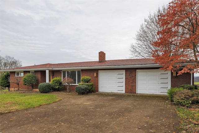 ranch-style home featuring a garage