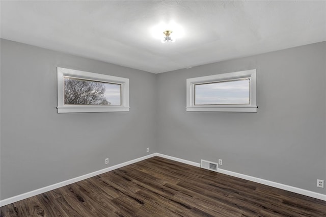 empty room featuring dark hardwood / wood-style floors