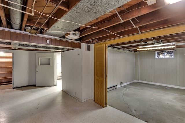 basement featuring a baseboard heating unit