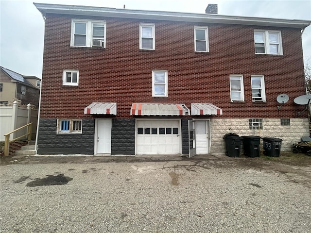 back of property with a garage