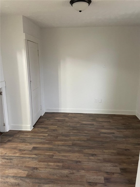 unfurnished room featuring dark hardwood / wood-style floors