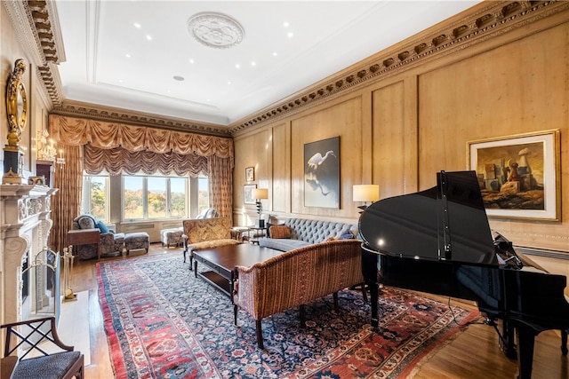 sitting room with wood-type flooring and ornamental molding