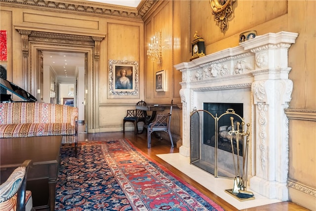 interior space with a fireplace, hardwood / wood-style floors, and ornamental molding