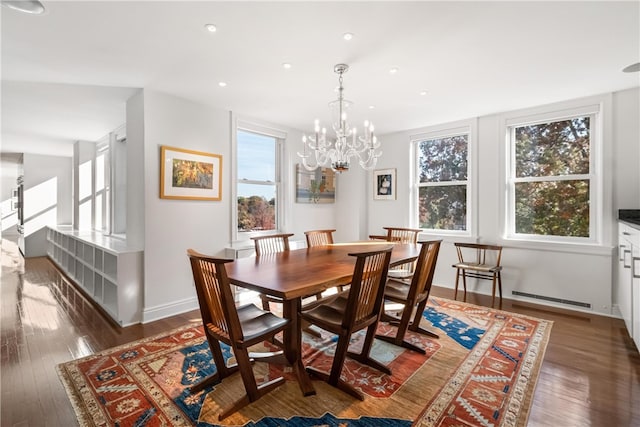 dining area with dark hardwood / wood-style flooring and a chandelier