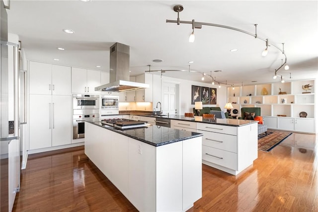 5023 Frew Unit 6Bc, Squirrel Hill, PA 15213 - kitchen featuring island exhaust hood, a peninsula, a sink, modern cabinets, and white cabinets