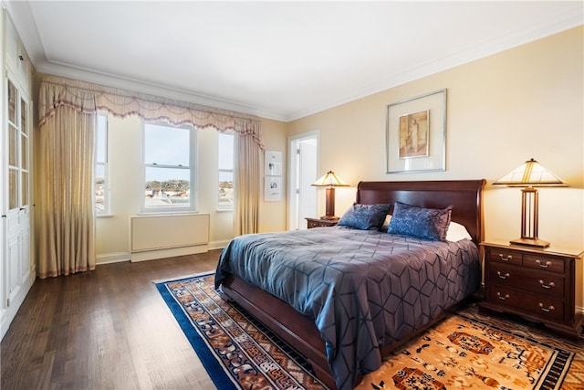 bedroom featuring dark hardwood / wood-style flooring and crown molding