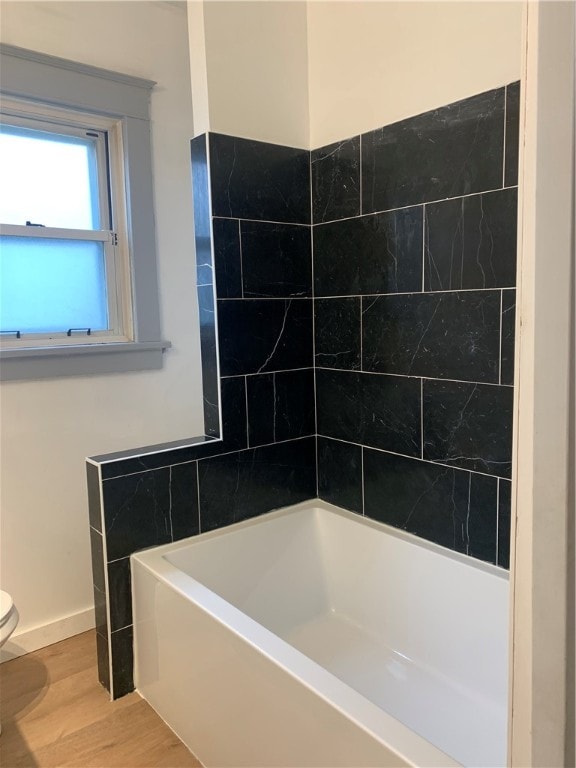 bathroom with hardwood / wood-style floors and toilet