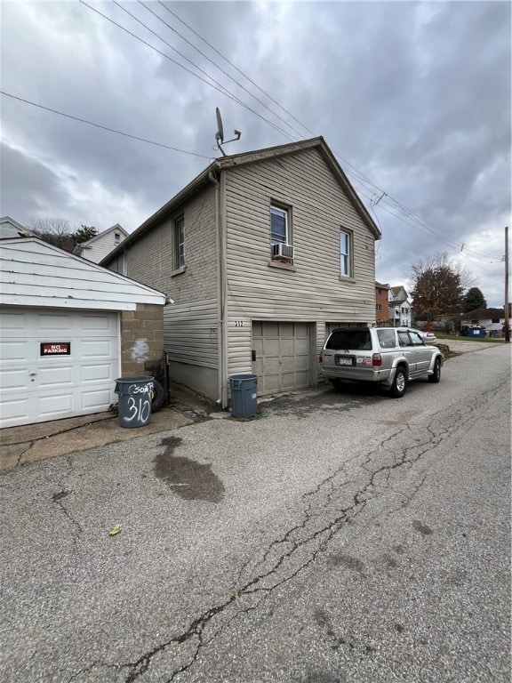 exterior space with cooling unit and a garage