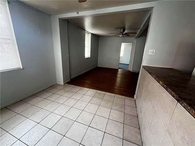 unfurnished room featuring light tile patterned floors and a ceiling fan