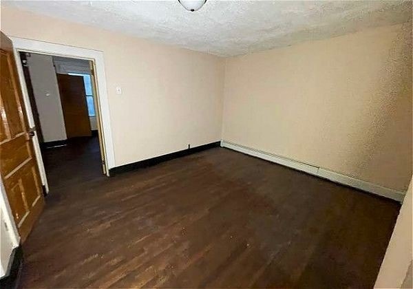 empty room featuring dark hardwood / wood-style flooring