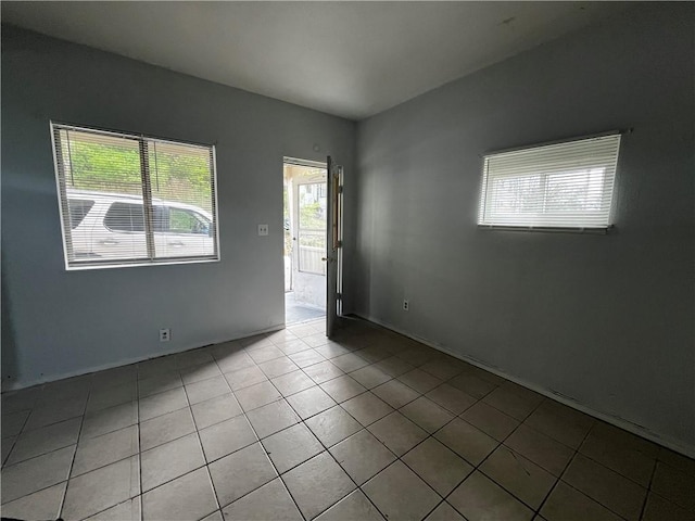 spare room with light tile patterned floors