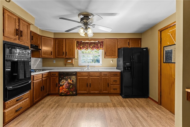 kitchen with sink, light wood-type flooring, ceiling fan, and black appliances