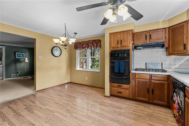 kitchen featuring pendant lighting, backsplash, black appliances, ceiling fan with notable chandelier, and light hardwood / wood-style flooring