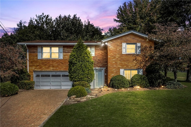 view of front of home with a lawn and a garage