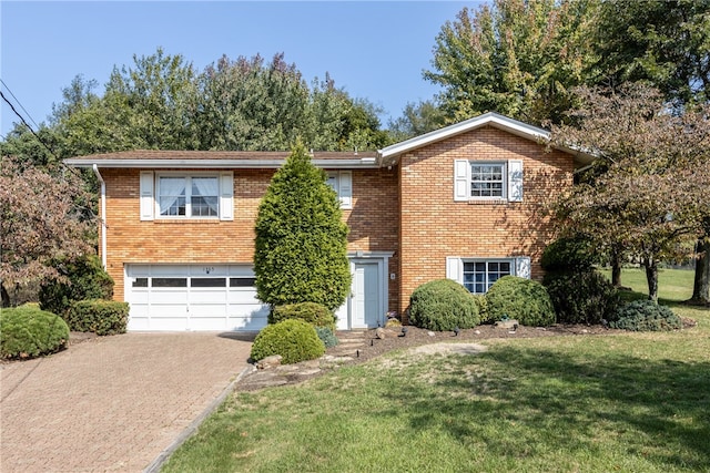 view of front of home with a garage and a front lawn