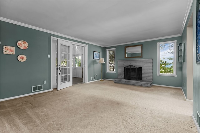 unfurnished living room with carpet flooring, a fireplace, french doors, and ornamental molding