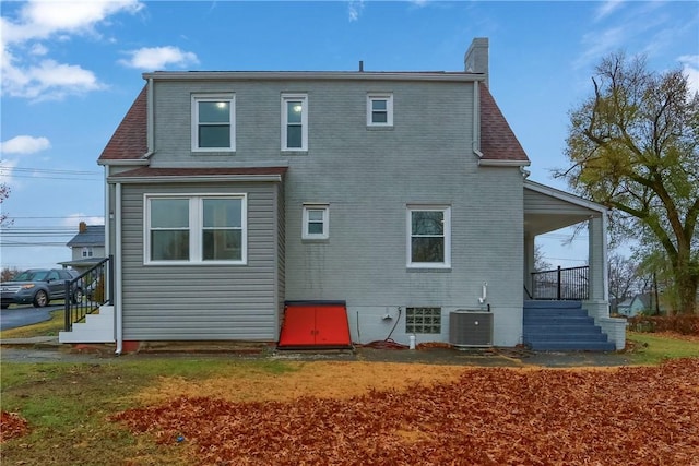 rear view of house featuring central AC unit