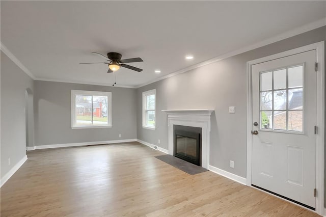 unfurnished living room featuring ceiling fan, crown molding, and light hardwood / wood-style flooring