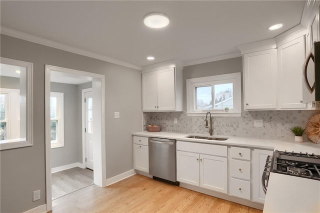 kitchen featuring stainless steel dishwasher, white cabinets, sink, and light hardwood / wood-style flooring